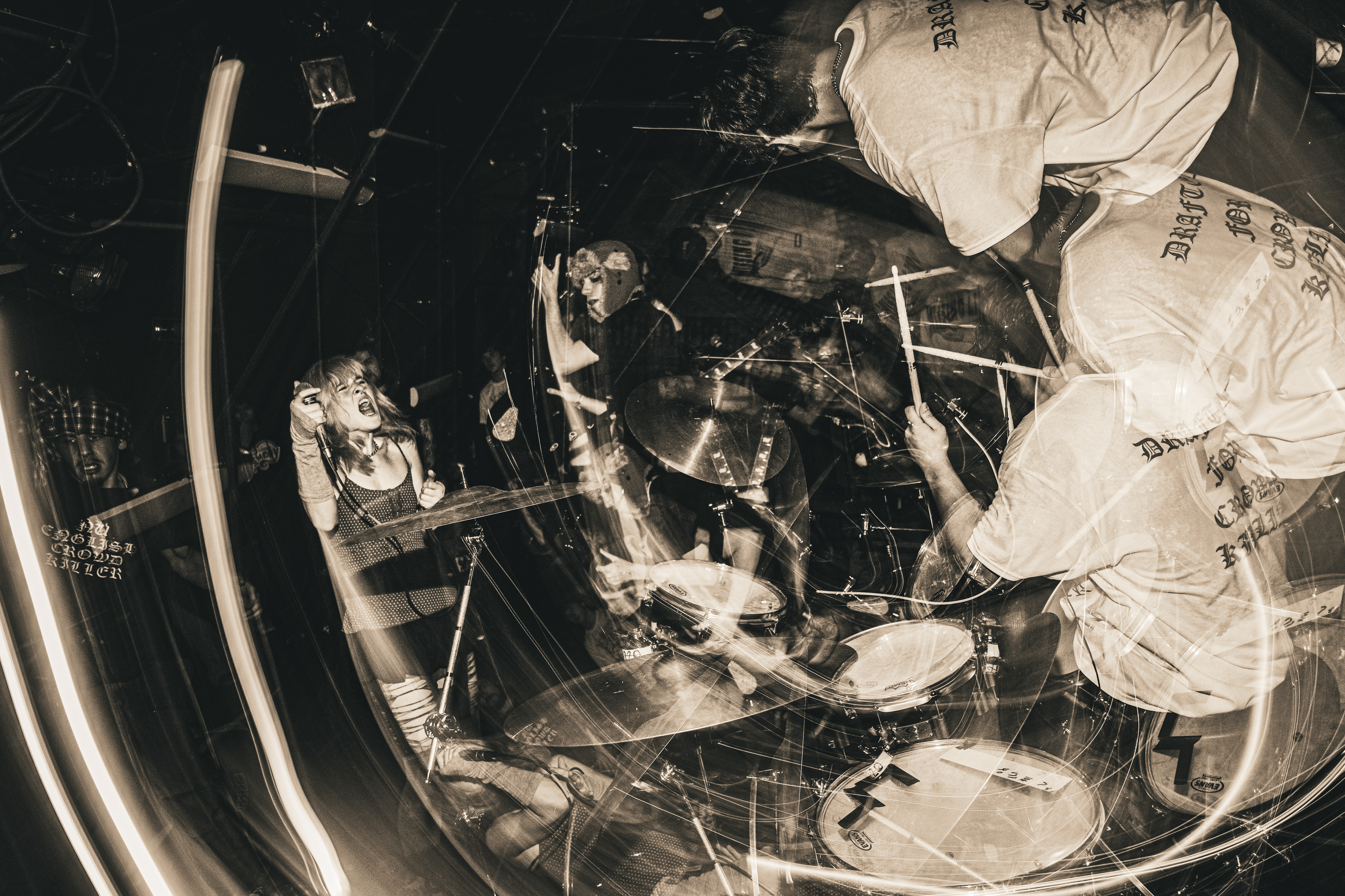 Motion of a punk concert captured, with light trails across the photograph.